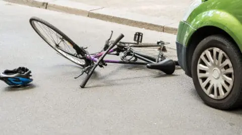 Damaged Bike on Ground After a Car vs. Bicycle Accident